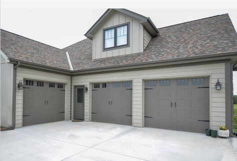 The exterior walls are Intellectual Gray (SW 7045) and the trim is Porpoise (SW 7047). Gray Garage, Grey Garage Doors, Intellectual Gray, Grey Exterior House Colors, Gray House Exterior, House Paint Color Combination, Garage Door Makeover, Exterior House Paint Color Combinations, Exterior House Color