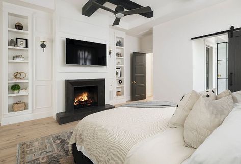 Modern Farmhouse Bedroom Fireplace. One of our favorite features in this master bedroom is the Basalt stone fireplace surround selected by the interior designer. The black wood beams in the ceiling continue our black/white theme throughout this custom home. Another fun feature is the decorative bookcase on either side of the fireplace. Modern Farmhouse Bedroom Fireplace. Modern Farmhouse Bedroom Fireplace. Modern Farmhouse Bedroom Fireplace Modern Farmhouse Bedroom Fireplace Modern Farmhouse ... Bedroom Fireplaces, Warm Bedroom Ideas, Bedroom Window Seat, Trendy House, Bedroom With Sitting Area, Warm Bedroom, Modern Farmhouse Bedroom, House Of Turquoise, Decor Ikea