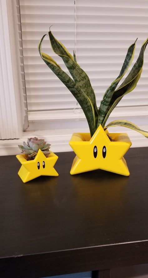 "Super Mario Super Star Planter!!  Kirbys Star Planter. Accepts all types of plants from succulents to medium sized indoor/ outdoor plants.  Style how you see fit Small is great for Succulents  Aloe, Echeveria.  Large is great for Snake plants, Dracaena's 2 Sizes Available Small 2.5\" Tall X 3\" Wide Large 4.25\" Tall x 5\" Wide Plants not included" Plant Decorated Room, Gamer House Decor, Kirby Planter, Unique Plant Pots, Clay Plant Holder, Nerdy Living Room, Cool Home Decor Ideas, Funky Planters, Nerd Home Decor