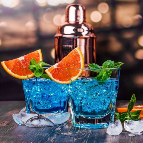 Pick your bluesy poison! The inviting, dreamy quality of blue cocktails is tough to ignore. Show off your mixology skills and wow your friends and family with any of these 23 easy, fun blue cocktails. Blue Rum Cocktails, Blue Cocktails Aesthetic, Blue Cocktail Drinks, Blue Martini Recipe, Blue Alcoholic Drinks, Blackberry Cocktail, Cocktail Recipes For A Crowd, Blue Gin, Girly Drinks