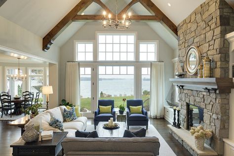 ** Saving this again** Trusses on ceiling -  Furniture placement (couches with end table and large coffee table and 2 chairs in front of windows. Stone fireplace (this has bookshelves on both sides - maybe a door and window). Open to the lower ceiling dining behind. Lake House Living Room, Lake House Interior, Farmhouse Living Room Decor Ideas, Rustic Farmhouse Living Room, Farmhouse Style Living Room, Living Room Furniture Arrangement, Living Room Design Ideas, Style Living Room, Furniture Placement