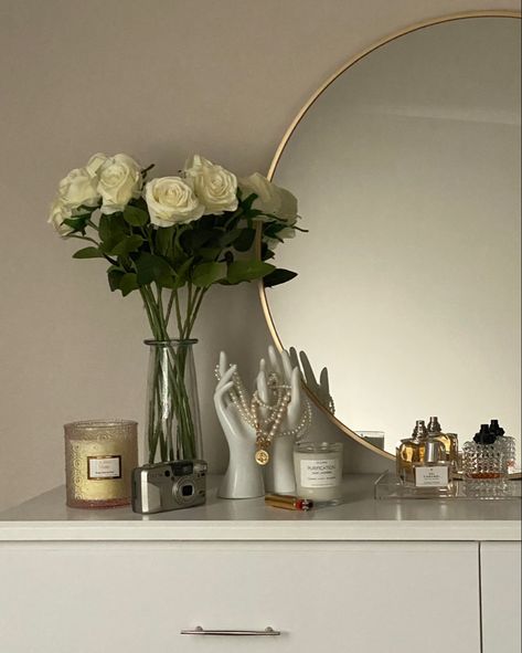 White aesthetic bedroom decor
White dresser
White flowers
Big circle mirror
Clean girl aesthetic 
Minimalist decor
Perfume display
Pearl necklace display
Bedroom ideas
Room ideas
Home decor
Dorm decorations 
College girl bedroom
Soft girl decor Classy Room Decor, Classy Dorm Room, Nail Suite, Dresser Decor Bedroom, Classy Rooms, Gold Rooms, White Room Decor, Comfy Bedroom, Classy Bedroom