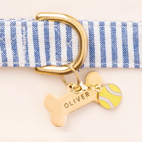 Your best fur-iend has a lot of personality, so why not show it off with a “charm”-ing collar accessory? Double-sided and made of durable enamel, this tennis ball charm is perfect for dogs who love playing catch. Easily attaches to the D ring of your dog’s collar with either the split ring or lobster clasp (both included) Charm is double-sided so the design shows in all directions Hard enamel design is extra durable with a special coating to prevent chipping and scratches Air Tag Dog Collar, Preppy Dog Collar, Cool Dog Collars, Dog Tags For Dogs, Dog Brand, The Foggy Dog, Collar Accessory, Bandana Bow, Puppy Collar