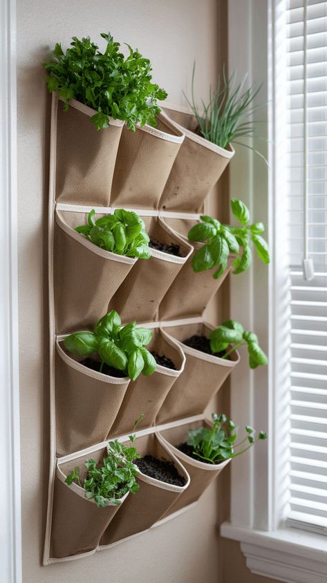 Create a vertical herb garden with hanging pockets! This DIY is great for small spaces, letting you grow fresh herbs right on your wall. Ideal for kitchens and balconies! Kitchen Herbs Garden, Wall Garden Ideas Indoor, Kitchen Herb Wall, Small Space Garden, Indoor Garden Apartment, Vertical Herb Gardens, Kitchen Herb Garden, Plant Store, Hanging Herb Garden