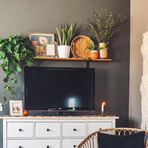 Sara Uribe 🌻 on Instagram: "Sometimes you just need to hide out in your room and eat your kids Halloween candy 🙈🤫 #bohostyle #bohohome #bohohomedecor #bohodecor #bohoinspired #boholivingroom #wickercabinet #rattanchair #plantstyle #plantsmakemehappy #bedroomdecor #tvshelf #shelfabovetv #mycurrentview #cozyhome #cozystyle #homedecor #myhomestyle #plantstyle #myhomevibe #gofinding #homegoods #collectedhome #dad110420ls #iny110420l" Over The Tv Shelf Decor, Above Tv Shelf Decor, Shelving Above Tv, Shelf Above Tv Decor, Shelf Above Tv Living Room, Above Tv Shelf, Shelves Above Tv, Shelf Over Tv, Above Tv Decor