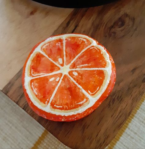 Orange slice painted rock! How To Paint An Orange Slice, Slice Of Pie Painted Rock, Clay Orange Slice, Orange Rock Painting, Fruit Coasters Paint, Orange Painted Rock, Painted Rocks Food Stones, Orange Painting, Orange Slices