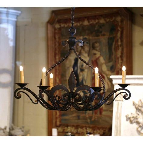 Add a touch of Gothic style to your house with this elegant light fixture. Forged in Normandy, France circa 1920, and oblong in shape, the antique chandelier features a large hand forged Fleur-de-Lys motif in the center; it has six lights newly wired and dressed with decorative candle sleeve covers. The Gothic style chandelier is in excellent condition and adorns a rich patinated black finish throughout. A wonderful addition in any kitchen, wine cellar or entry for a true Medieval or Gothic look Medieval Lighting, Medieval Chandelier, Kitchen Wine Cellar, French Gothic, Wrought Iron Candle, Candle Sleeves, Gothic Looks, Antique Chandelier, Normandy France