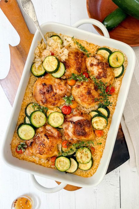 This One Pan Chicken and Rice with Zucchini and Tomatoes is the easiest one pot chicken and rice casserole ever. Using dry rice, it's a simple prep dish for busy weeknights that's delicious with Spanish-inspired flavors, tender chicken and perfectly cooked rice. And then drizzled in a Garlic Honey Sauce. The zucchini and tomatoes are vibrant and delicious, truly making it a one-pan meal. Rice With Zucchini, One Pan Chicken And Rice, One Pot Chicken And Rice, Zucchini And Tomatoes, Garlic Honey, Chicken And Rice Casserole, Main Dish Casseroles, Dry Rice, One Pan Chicken