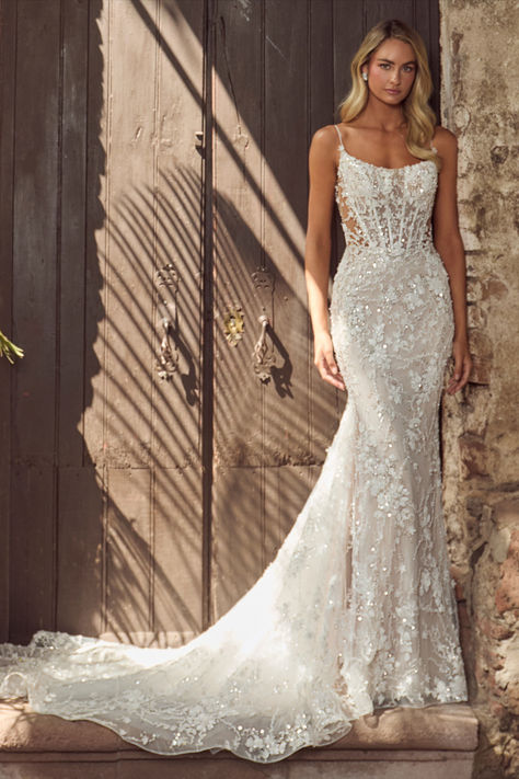 In this wedding dress with an overskirt,there’s no doubt in our minds that you’ll evoke the same majesty of Hera and feel just as beautiful as the goddess herself.Featuring a sheath silhouette adorned with sparkling sequins and intricate lace,this dress transforms with a detachable overskirt,making the arrival at the reception even more breathtaking.Her spaghetti straps create an airy feel, while her low back exudes allure, allowing brides to glide down the aisle while  blending sophistication. Strappy Sheath Wedding Dress, Mermaid Wedding Dress Corset Top, Lace Sparkly Wedding Dress, Floral Lace Wedding Dress Fitted, Fitted Wedding Dress Sparkle, Wedding Dresses Fitted Lace, Fitted Sparkly Wedding Dress, Wedding Dresses With Overskirt, Tight Wedding Dress Open Backs