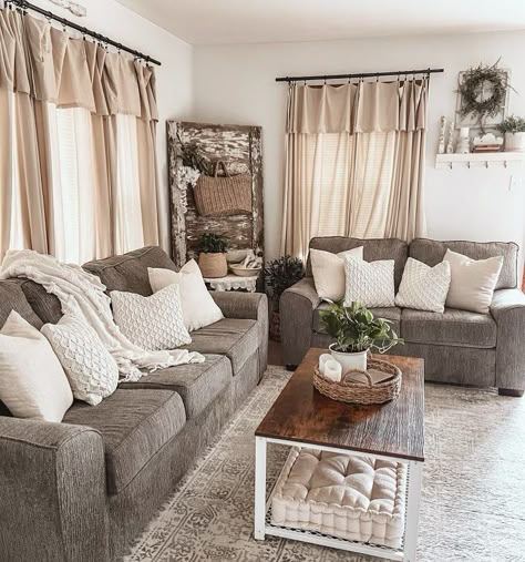 Two dark grey couches, layered with white cushions, and a matching wooden coffee table rest atop an intricately patterned beige rug in this living room. Completing this space are window curtains in muted tones and a rustic wood feature wall at the back. Dark Grey Couch Living Room, Grey Walls Living Room, Couches Living, Grey Couch Living Room, Kabinet Dapur, Modern Farmhouse Living Room, Brown Living Room, Farmhouse Decor Living Room, Living Room Remodel