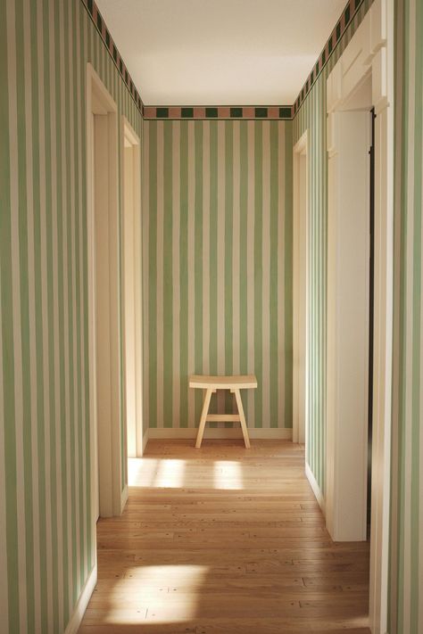 Koi Studio's new 'The Bold Stripe' wallpaper blends nostalgic vintage home decor with a contemporary twist. Make an impact with BelarteSTUDIO's exclusive interior design murals and create a unique and eclectic home online at belartestudio.com. Fun Hallway Wallpaper, Green And Pink Striped Wall, Striped Interior Design, Striped Wallpaper Entryway, Green Striped Wall, Contemporary Eclectic Interior Design, Stripped Walls Ideas, Paint Stripes On Wall, Striped Wallpaper Hallway