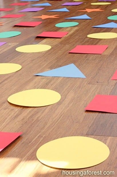 10 Indoor Activities for Preschoolers - 5 Minutes for Mom Indoor Hopscotch Ideas, Shape Hopscotch Game, Preschool Games Movement, Indoor Activities For Preschoolers, Shape Games For Kids, Shape Activities Preschool, Shapes Kindergarten, Diy Kids Games, Fun Indoor Activities