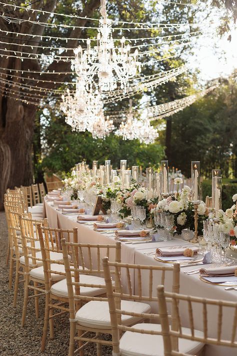 Lighting decoration with fairy lights and hanged crystal chandeliers, for outdoor wedding dinner. #weddingmusicandlights #weddingsolution #weddingidea Chandelier Decorations Wedding, Chandelier Outside Wedding, Wedding Chandelier Ideas, Hanging Chandelier Wedding, Decoration With Fairy Lights, Outdoor Wedding Dinner, Chandelier Wedding, Lighting Decoration, Wedding Chandelier