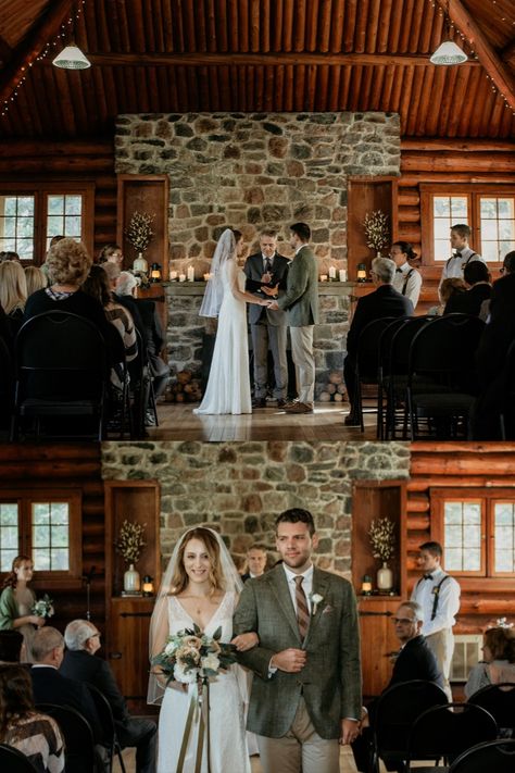 Candlelight wedding ceremony in front of the stone fireplace in Waskesiu Community Hall.  Autumn lake wedding in Waskesiu Lake, Prince Albert National Park, Saskatchewan, Canada. Unique event and wedding venues in Saskatchewan. Lakeside wedding with vintage rustic decor and details in cozy log cabin. Lakefront cottage wedding with neutral greens and browns. Waskesiu wedding by Saskatchewan wedding photographer Copperblue Photography and Design #saskatoon #yxe #yxewedding #saskatchewan #waskesiu Ceremony In Front Of Fireplace, Wedding Ceremony In Front Of Fireplace, Log Cabin Wedding Decorations, Wedding In Front Of Fireplace, Fireplace Wedding Ceremony, Candlelight Wedding Ceremony, Stone Fireplace Decor, Log Cabin Wedding, Candlelight Wedding