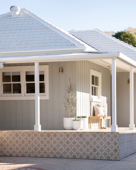 The vertical cladding, trims, eaves and wide window trims used a fresh lick of Dulux Pozieres and Dulux White Dune paint to bring this exterior to life. Weatherboard Exterior, Weatherboard House, Roof Restoration, Porch Tile, Three Birds Renovations, Pintura Exterior, Cottage Renovation, Three Birds, Contemporary Cottage