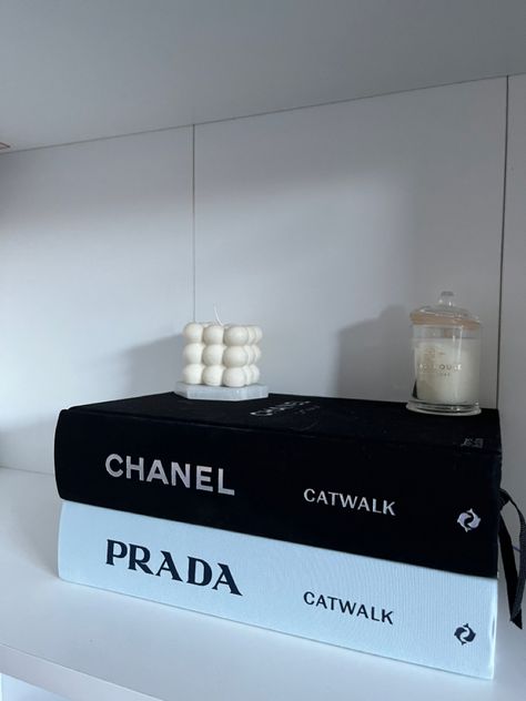 Prada Book Decor, Channel Book Decor, Prada Sign Decor, Dior Aesthetic Bedroom, Prada Room Decor, Designer Books Aesthetic, Prada Decor, Catwalk Books, Photos Above Bed