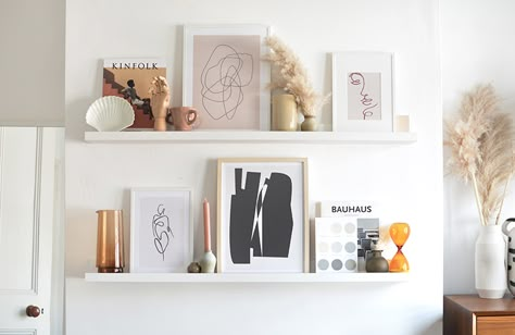 tips on styling a picture ledge Ikea Mosslanda Shelf Ideas, Picture Ledge Sizing Guide, Styling Ledge Shelves, Photo Ledge Decor, Styling Picture Shelves, Ikea Mosslanda Picture Ledge, 60 Inch Picture Ledge Layout, How To Style A Picture Ledge, Photo Ledge Above Bed