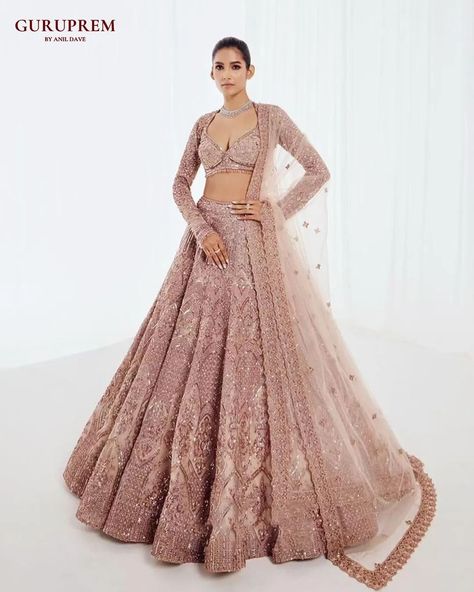 Discover the epitome of elegance with our stunning rose gold lehengas, meticulously handcrafted for the modern woman. Each piece in this high-end collection embodies the perfect blend of traditional craftsmanship and contemporary design. The delicate rose gold hue adds a touch of timeless sophistication, making these lehengas ideal for special occasions where you wish to stand out. Elevate your wardrobe with these exquisite garments, designed to make every moment memorable. Email : guruprem.... Global Wedding, Gold Lehenga, Bespoke Fashion, Elegant Attire, Indian Bride, Global Fashion, Exquisite Design, Modern Woman, Indian Fashion