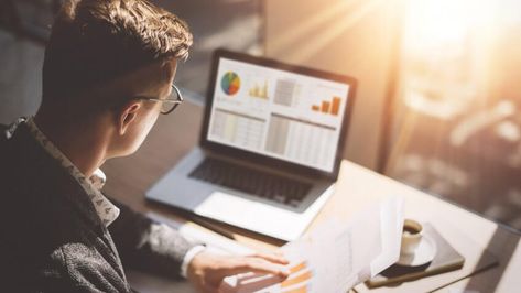 Young finance market analyst in eyeglasses working at sunny office on laptop while sitting at wooden table. Working Office, Free Budget, Investment Accounts, Marketing Budget, Best Credit Cards, Investment Advisor, Warren Buffett, Start Investing, Excel Templates