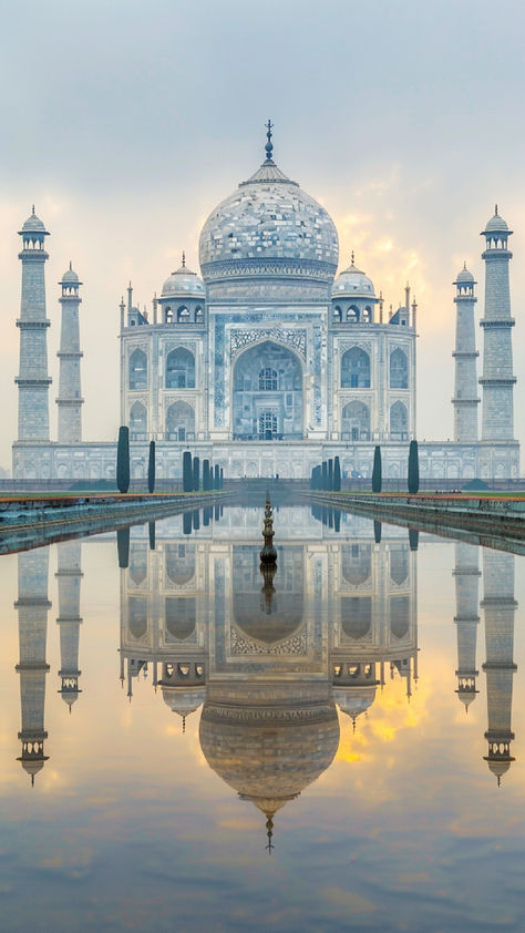 A stunning view of the Taj Mahal reflecting in the water, surrounded by a misty atmosphere and a soft sunrise in the background. Ancient Temples, Ancient Ruins, Machu Picchu, Unesco World Heritage Site, Unesco World Heritage, City Guide, Heritage Site, Travel Itinerary, World Heritage Sites