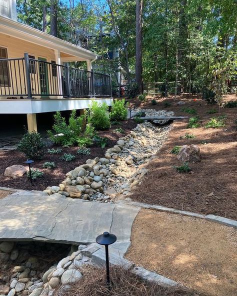 For Garden’s Sake on Instagram: "Don’t you wish you could look off that deck into this stunning backyard everyday? 🤨 With the help of our designers and landscape crews you could! Our team worked wonders installing this enchanting dry creek bed with flagstone bridges, decomposed granite walkways, outdoor lighting and lovely plantings. We just can’t get enough!👏🏻😍 #fgslandscapes #fgsdurham . . . #drycreekbed #flagstonebridge #smallbusiness #lawn #landscape #fgsdurham #plantlife #landscapedesig Creek Ideas, Dry Creek Bed, Lawn Landscape, Decomposed Granite, Creek Bed, Stone Bridge, Dry Creek, Fall Plants, Trees And Shrubs