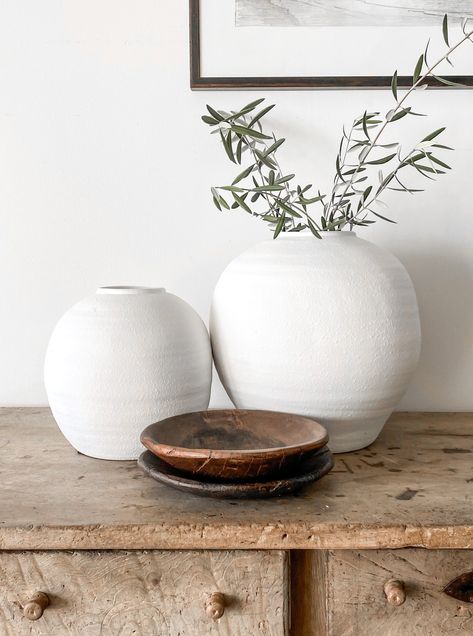 This stunning, white round bellied vase can stand alone or with other decor to beautify any home or lifestyle design. Filled with branches, this piece makes a gorgeous, simple centerpiece. One of our faves!! Medium: 10.75" Tall x 10.5" Wide x 3.75" Opening. Large: 14.5" Tall x 14.5" Wide x3.75" Opening Vase Branches Decor, White Vase Decor, Beach House Accessories, Modern Coastal Interior Design, Small Theatre Room Ideas, Large White Vase, Simple Centerpiece, Beachy Room, Console Table Decorating