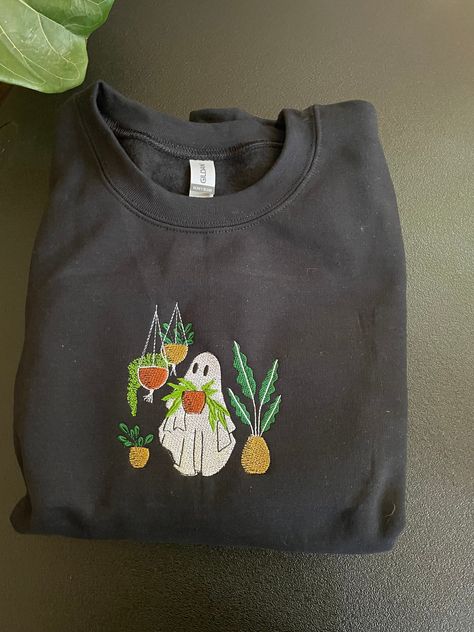 "Plant loving Ghost" embroidered on Gildan sweatshirt.  **SHIRTS ARE UNISEX** If you are wanting more of a relaxed fit, I would go up a size. If you are wanting a more fitted look, I would stick with your normal size. Please note that embroidered shirts or sweatshirtscome with the backing that stabilizes the fabric during the embroidery process.  Embroidery Care Instructions *machine wash cold, inside-out, on the gentle cycl, tumblwe dry on low* If you have any questions, feel free to message me Embroidery Halloween Sweatshirt, Embroidery Designs Shirts, Granola Goth, Plant Lover Gifts, Sweatshirt Shirts, Ghost Embroidery, Embroidery Shirts, Embroidery Clothing, Johnson City Tn