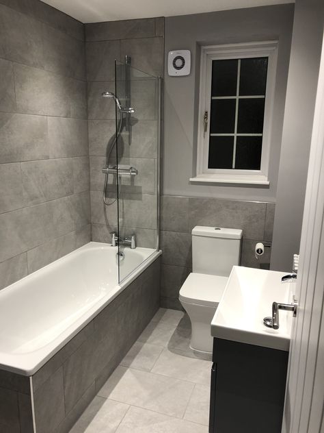 Re fitted bathroom with floating vanity unit and tiles bath panel. Bathroom With Bath Tub Ideas, Bathroom Ideas Small With Bath, Dark Grey Wall Bathroom, Bathroom Uk Ideas, Bathroom Wallpaper And Tile, Standard Bathroom Ideas, Half Bathroom Tile Ideas, Uk Bathroom Ideas, Small Grey Bathroom Ideas