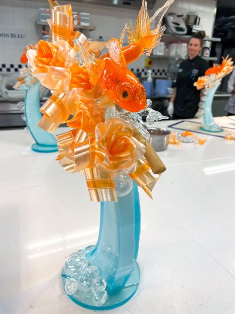 My experience participating in the Sugar Art Essential Techniques class at Le Cordon Bleu London, including the creation of an intricate goldfish themed sugarwork sculpture made using a mix of blown, pulled, and poured sugar techniques. Pulled Sugar Art, Blown Sugar, Sugar Sculpture, Confectionary Art, Art Essentials, Sugar Art, Goldfish, The Creation, Sculpture