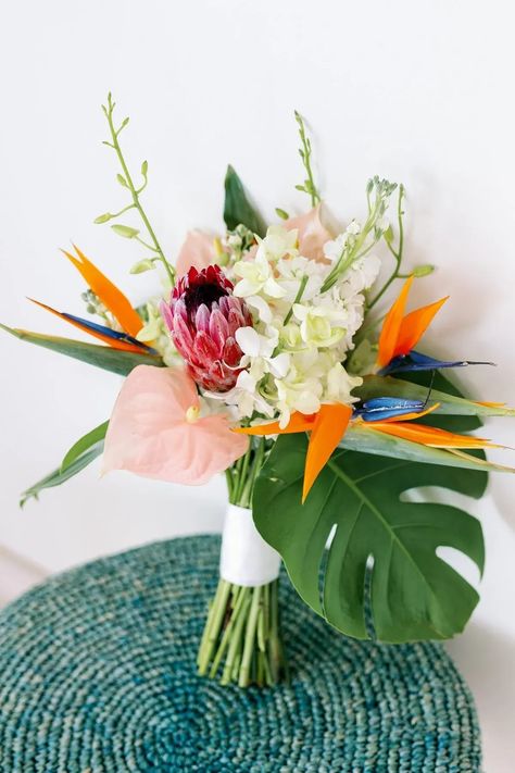 This bridal bouquet has all the Caribbean vibes. It was a bright and colorful tropical bouquet with birds of paradise, anthurium's and protea. Save this pin for when you are destination wedding planning and planning your Bahamian wedding. Diy Tropical Bouquet, Simple Tropical Bridal Bouquet, Tropical Wedding Hair Flowers, Tropical Bridal Bouquet Bright Colors, Small Tropical Bridal Bouquet, Hawaiian Bouquet Wedding, Birds Of Paradise Bouquet, White Tropical Bouquet, Tropical Bouquet Wedding