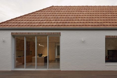 Courtyard House is a heritage-listed interwar bungalow. From the street, there is no visible presence of an addition beyond. But the Hawthorn home has undergone a fundamental transformation. The clients, a professional couple, aspired to an idyllic, minimalist sanctuary — with abundant natural light on the south-facing site. Although the property deserved substantial improvement, their brief was for a modest three-bedroom home on a similar footprint to the existing house. This was not an extensi Terracotta Roof House, Brick Roof, Terracotta Roof Tiles, Japanese Motifs, Terracotta Roof, Timber Screens, Roof Architecture, Modern Home Design, The Local Project