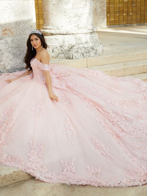 Make a royal statement in this off-the-shoulder gown featuring gorgeous metallic embroidery and lace appliqués. The bodice boasts a sweetheart neckline and short sleeves and tops a full ball gown skirt crafted of layers of luxe tulle. A large bow accents a dramatic train with lace appliqués. #QuinceaneraCollection Style #26022 Quinceanera Collection, Debutante Ball, Tulle Balls, Dress With Train, Metallic Embroidery, Off Shoulder Gown, Gown Skirt, Exquisite Gowns, Quinceanera Dress