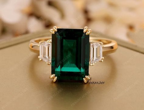 "★ RING INFORMATION ★ ------------------------------------------------------------------- ★ MAIN STONE ➺ SHAPE  :- Emerald Green cut  (lab created) ➺ Weight :- 4.90 ct (11 x 9 mm) (app.) ➺Gem color :  Green ➺Luster: Excellent ➺ Make: High Quality ➺Clarity : VVS ------------------------------------------------------------------- ★ SIDE DIAMOND  ➺ SHAPE  :-Trapezoid Cut Moissanite  ➺ Weight :- 0.50ct  ➺Gem color :  White/ Colorless ➺Luster: Excellent ➺ Make: High Quality ➺Clarity : VVS ------------------------------------------------------------------- ★ BAND  ➺ BAND WIDTH :- 1.8 mm  ➺ BAND THICKNESS :- 1.5 mm  ➺ Metal Tone: Yellow Gold , White Gold , Rose Gold (10KT,14KT,18KT) ➺ Finish : High Polished All stone are fixed with prong setting 3.5ct Emerald Diamond Engagement Ring 14k Solid gol Wedding Ring Minimalist, Emerald Diamond Engagement Ring, Emerald Ring Engagement Diamond, Minimalist Engagement Ring, Dream Engagement Rings, Emerald Engagement, Diamond Wedding Ring, Ring Minimalist, Emerald Engagement Ring