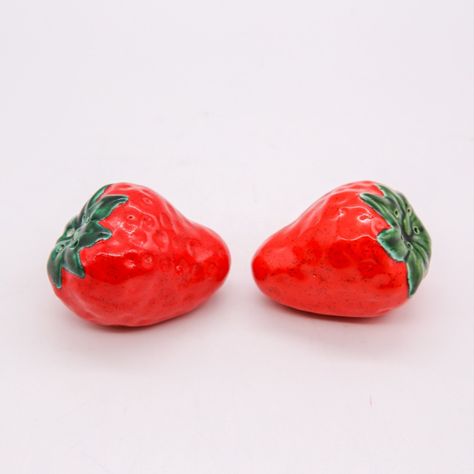 Fun and funky! Strawberry shaped salt and pepper shakers would be a fun addtion to any red kitchen. These shakers are shaped like actual strawberries and feature a dimpled exterior to mimic the exterior of a real strawberry. They are topped with dark green "leaves" which have the holes to shake out the salt or pepper. Shakers sit flat and have a red, pliable grommet to hold the seasonings in place. Ceramic Salt And Pepper Shakers, Ceramic Salt And Pepper, Vintage Strawberry, Red Kitchen, Salt And Pepper Shakers, Salt Pepper Shakers, Salt And Pepper, Green Leaves, Strawberries