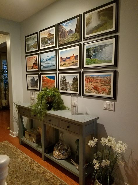 Photo wall great way to display your trips. Display Photography At Home, How To Display A Lot Of Pictures, Displaying Vacation Photos, Display Landscape Photos, Nature Photo Wall, Travel Photo Collage Wall, Vertical Photo Wall Display, Travel Photo Gallery Wall, Family Photos Wall Display