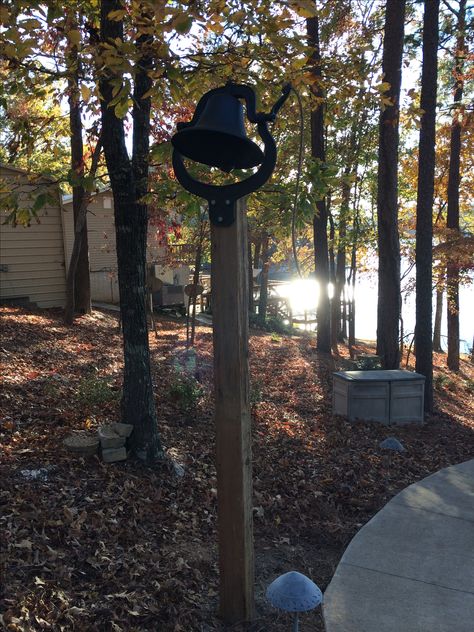 Grandmother's dinner bell, which is mounted on a cedar post leftover from our house renovation. Dinner Bell Post, Cast Iron Bell, Metal Deck Railing, Bell Gardens, Antique Bell, Cedar Posts, Vintage Dinner, Dinner Bell, Outdoor Dinner