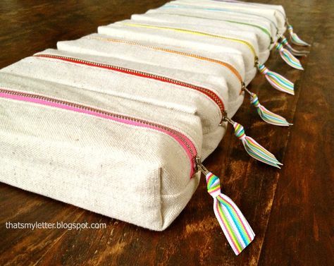 Sew: boxy pencil pouches Easy to sew boxy drop cloth canvas pencil pouches with rainbow print lining and rainbow colored zippers. These pencil pouches are part of a party favor. I made these pencil holder party favors and then started thinking about how the girls would transport their favors home? Solution: boxy pencil pouches: I used... Read more Pencil Pouch Diy, Pencil Case Tutorial, Pencil Case Sewing, Pencil Case Pattern, Pencil Pouches, Diy Pencil Case, Zipper Pencil Case, Diy Pencil, Pouch Diy