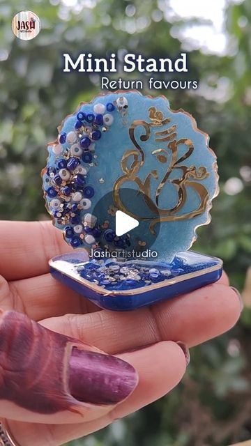 JASH Art Studio by Pooja Shah on Instagram: "Mini stands 🙏🙏

You can have this as return favour for your all occasions ✨✨

DM to Get Yours
Sticker by @anav_crafts
Resin  from @resin.era
Mould by @themouldstory

#reelitfeelit #ganesha #reelkarofeelkaro #reels #evileye #tutorialsvideos #resinartwork #resinplate #artreels #tutorial #evileye #resin2022 #resintutorial #resinartwork #resinobsession #resinphotoframe #resinpour #resinart #explore #artistsoninstagram #trending #giftideas #giftforlovedones #explorepage #explorereels" Resin Pour, Resin Artwork, Resin Tutorial, Ganesha, Resin Art, Art Studio, Photo Frame, Diy Projects, Gifts