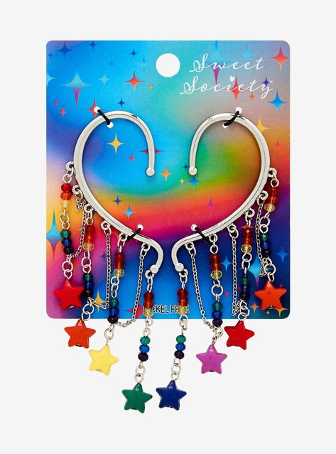 Add a sparkle of color to your look with this ear cuff set! Featuring cascading chains with rainbow beads and star charms.4'' dropsNickel-free alloy; acrylicSet of 2Imported Star Earrings Aesthetic, Silly Jewelry, Hoarding Board, Lgbtq Jewelry, Ear Cuff Diy, Alt Accessories, Weird Earrings, Scene Jewelry, Emo Accessories