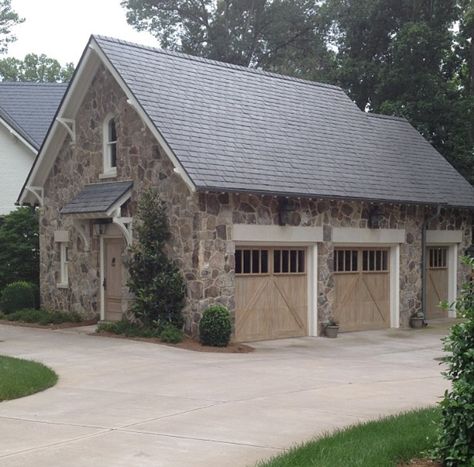 Stone garage with limestone headers and cerused doors Stone Garage, Canvas Awnings, Carriage House Garage, Garage Door Types, Carriage House Plans, Appliance Garage, Garage Door Design, Exterior Stone, Doors And Windows