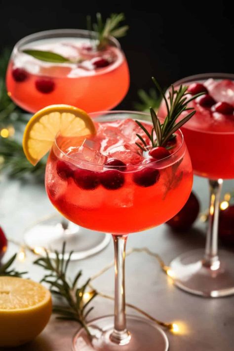 sparkling glass of Santa's Spritz Christmas Cocktails, with rich red cranberry juice, bubbly prosecco, and a hint of ginger gin, garnished with a sprig of rosemary. Loaded Mashed Potato Balls, Orange Mocktail, Rhubarb And Ginger Gin, Cranberry Mimosa, Pumpkin Cream Cheese Pie, Cranberry Margarita, White Cranberry Juice, Spritz Cocktail, Best Champagne