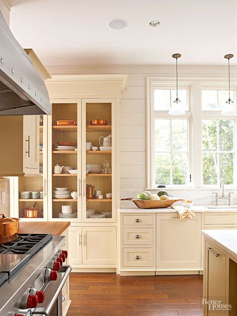 Tall Kitchen Cabinets With Glass Doors, Cabinet Next To Window, Light Yellow Kitchen Cabinets, Glass Cabinets Kitchen, Kitchen Back Door, Cream Kitchens, Kitchen Armoire, Cream Kitchen Cabinets, Kitchen Display Cabinet