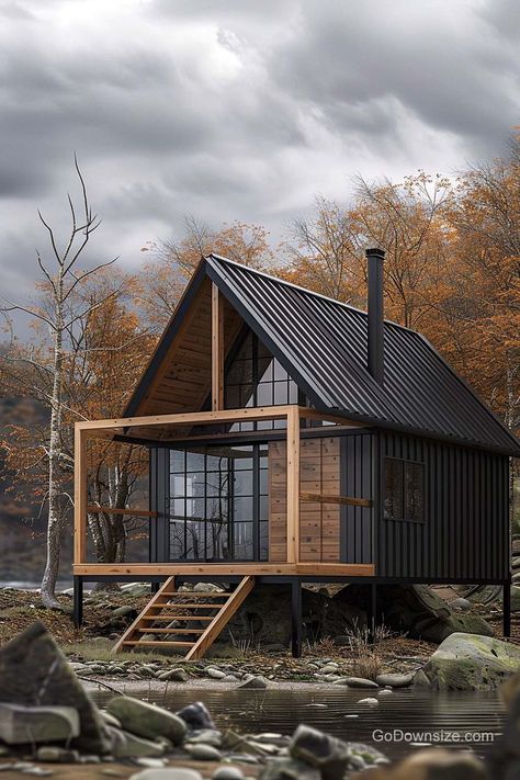 Here, the sleek black exteriors and metal roofs look like something out of a design magazine, right? Black Small House, Modern Small Cabin Design, Small Cabin Exterior Colors, Mountain Tiny House, Black Cabin In The Woods, Tiny House Mountains, Metal House Exterior, Forest House Mountain, Small Modern Cabin With Loft