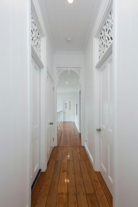 A beautifully renovated Queenslander home hallway featuring heritage breezeways and archways. #queenslanderhouse #queenslanderstyle #queenslanderhome #queenslander #queenslanderrenovation #brisbanerenovation Queenslander Homes Interior, Queenslander Homes Exterior, Renovated Queenslander, Queenslander Architecture, Queenslander Renovation, Queenslander House, Home Hallway, Weatherboard House, Interior Exterior Doors