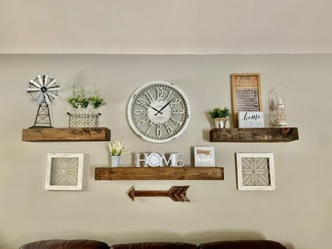 Floating Wall Shelves Above Couch, Over The Coach Wall Decor, Above Tv Shelf Ideas, Shelf Above Wall Mounted Tv, Three Shelves Above Couch, Wall Clock With Shelves, Mirror And Shelf Wall Decor Living Room, Floating Shelves With Clock, Clock And Shelves Wall Decor