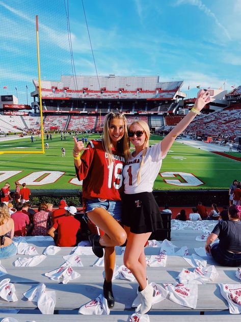 University of South Carolina Gameday Outfit Inspo | College Tailgate | Football Jersey | Gamecocks , college gameday , SEC , sorority girl , sorority life , greek life , UofSC , football field , best friends poses , jersey outfit , garnet , black , white , blonde hair , pretty sky , tailgate , fall fashion , Saturday, white boots , black boots , jean shorts , sorority pin Gamecocks Outfit, Usc College, Girly Games, College Tailgate, College Gameday Outfits, College Tailgating, Usc Gamecocks, Football Jersey Outfit, White Blonde Hair