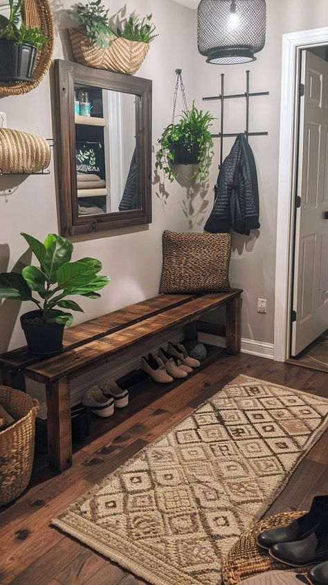 Cozy and organized entryway with wooden bench, woven basket, hanging plants, framed mirror, and geometric rug. Functional and stylish home decor ideas. Victorian Room Ideas, Organized Entryway, Storage For Shoes, Victorian Room, Entry Way Decor, Shoe Bench Entryway, Textured Rug, Shoe Storage Ideas, Living Single