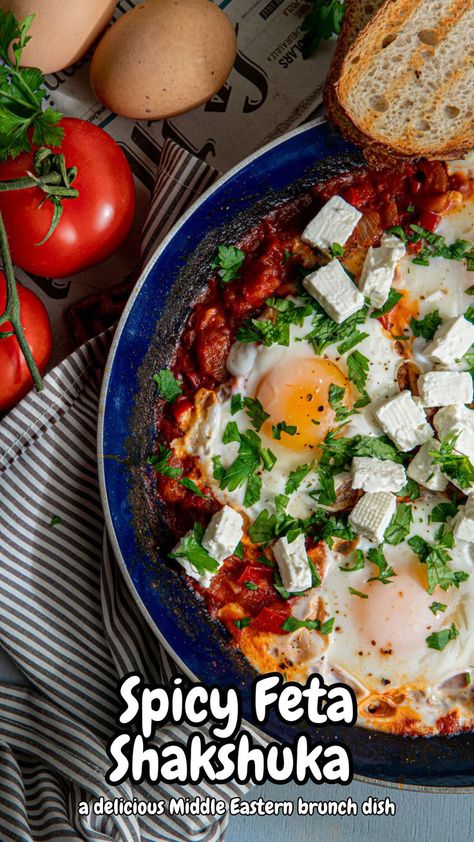 A vibrant skillet of Spicy Feta Shakshuka, featuring poached eggs nestled in a savory tomato sauce, topped with crumbled feta and fresh herbs. This Greek-inspired dish is perfect for a satisfying breakfast or a healthy lite dinner option. Middle Eastern Brunch, Shakshuka With Feta, Spicy Feta, Creamy Feta, Nutrient Packed Smoothies, Plant Based Dinner, Spicy Tomato Sauce, A Healthy Breakfast, Brunch Dishes