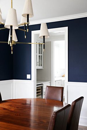 Navy dining room with paneled wainscoting walls Navy Panelling Dining Room, Navy Blue Wainscoting, Navy Wainscoting, Paneled Wainscoting, High Gloss Dining Room, Navy Dining Room, 1940 House, Dining Room Navy, Dining Room Wall Color