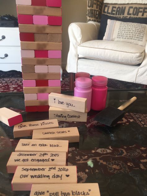 DIY Cute Valentine's Day Gift Game for him. Painted sides of blocks with pinks and reds while leaving a few of the ends raw. Wrote down special dates, places, quotes, fun rules, etc. Fun! I found an old Jenga game and some paint - cheap, easy handmade and so so sweet! :) Jenga Anniversary Gift, Pink Jenga, Jenga Game Diy, Jenga Painting Ideas, Diy Board Game Ideas, Game Ideas For Adults, Board Game Ideas, Places Quotes, Homemade Board Games